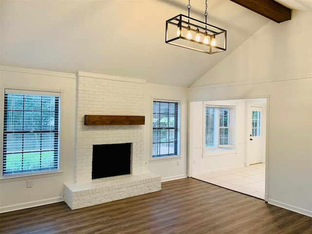 unfurnished living room featuring vaulted ceiling with beams, dark hardwood / wood-style flooring, and a fireplace