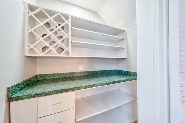 kitchen featuring white cabinets and built in desk