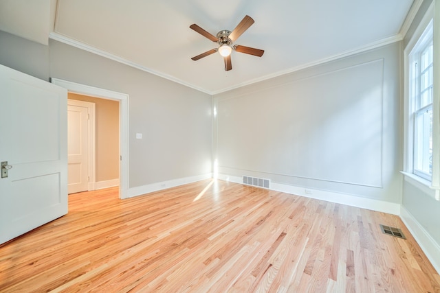 spare room with ceiling fan, light hardwood / wood-style flooring, and crown molding