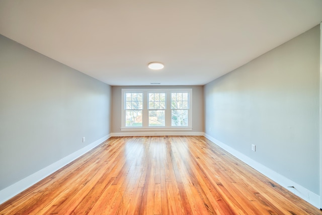 unfurnished room with light hardwood / wood-style flooring