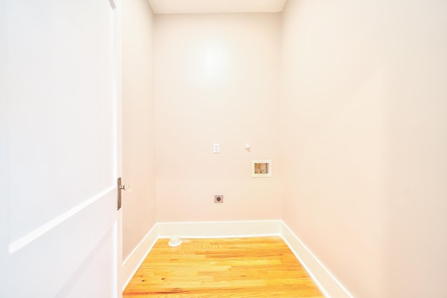 clothes washing area featuring hookup for an electric dryer, hardwood / wood-style flooring, and hookup for a washing machine