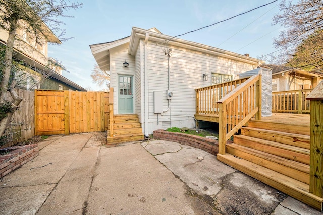 rear view of house featuring a patio and a wooden deck