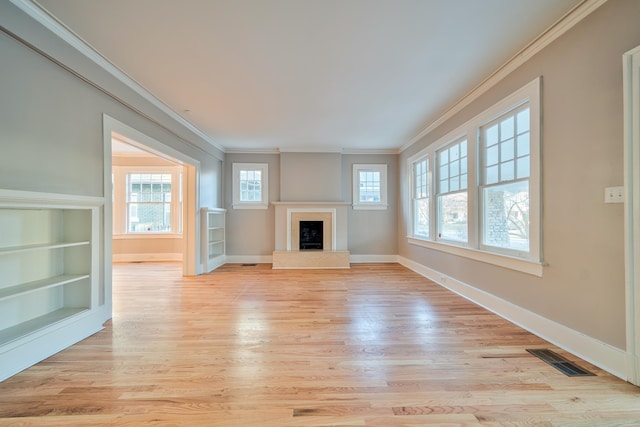 unfurnished living room featuring light hardwood / wood-style floors, built in features, and ornamental molding