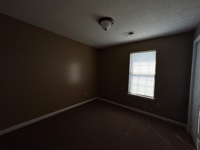 empty room featuring a textured ceiling