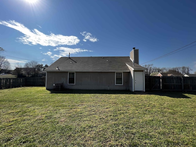 rear view of property with a yard and central AC unit