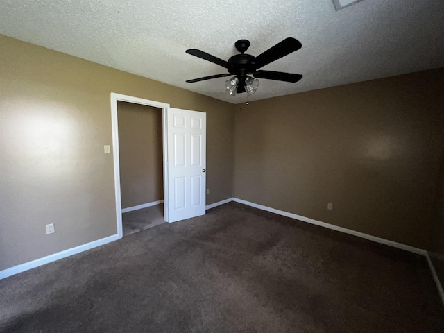 unfurnished bedroom with dark colored carpet, a textured ceiling, and ceiling fan