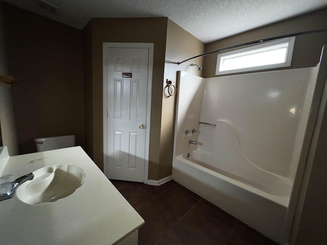 full bathroom featuring shower / bathtub combination, vanity, a textured ceiling, tile patterned flooring, and toilet