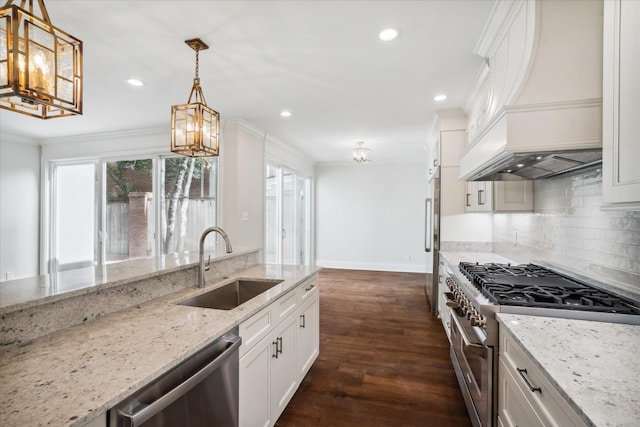 kitchen featuring light stone counters, custom exhaust hood, high end appliances, sink, and pendant lighting