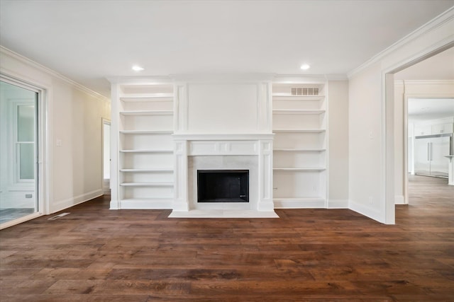 unfurnished living room with built in features, a high end fireplace, dark hardwood / wood-style floors, and ornamental molding