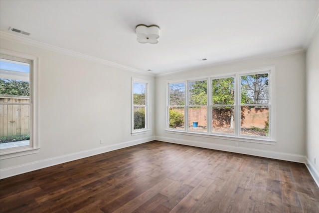 empty room with crown molding and dark wood-type flooring