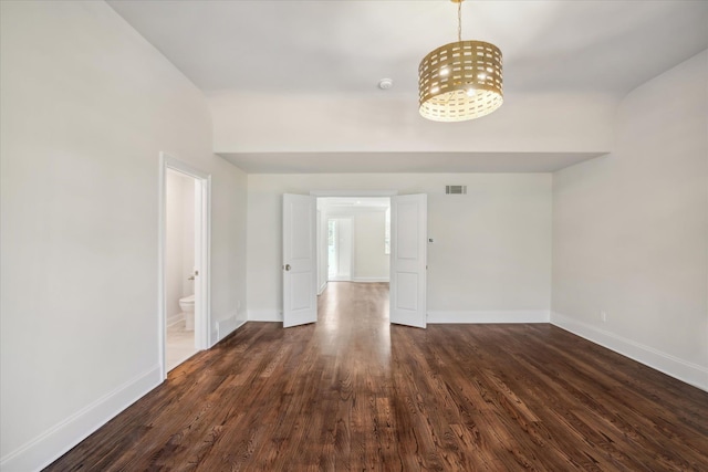 spare room with dark wood-type flooring