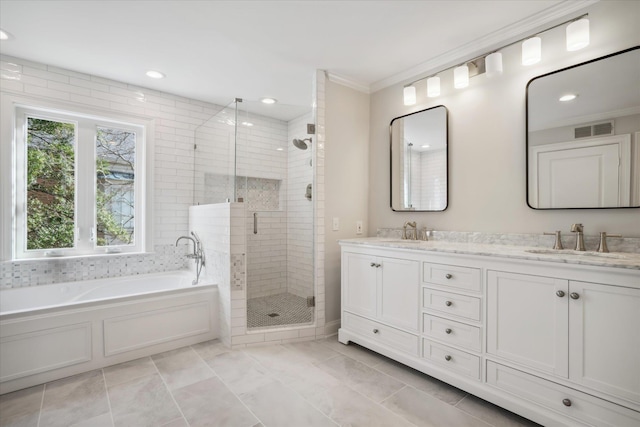 bathroom with vanity, crown molding, and independent shower and bath