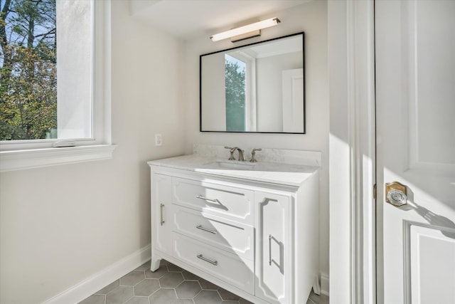 bathroom with tile patterned floors, a wealth of natural light, and vanity