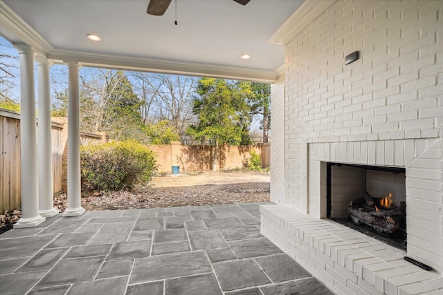 view of patio featuring ceiling fan and an outdoor brick fireplace