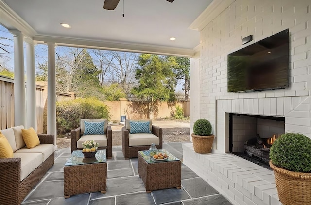 sunroom featuring an outdoor brick fireplace and ceiling fan