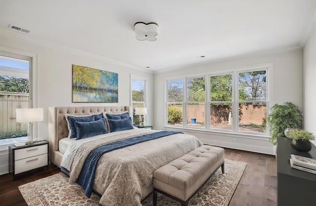 bedroom with multiple windows, crown molding, and dark wood-type flooring