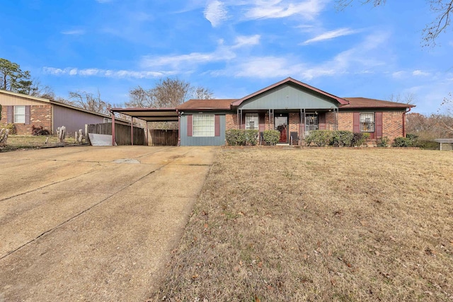 single story home with a front lawn and a carport