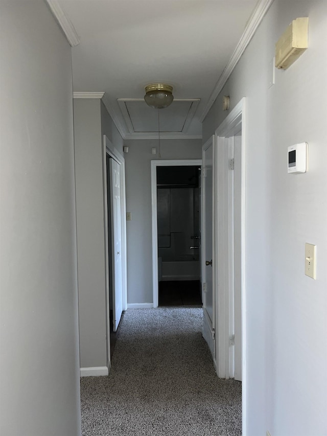 hallway featuring crown molding and dark carpet