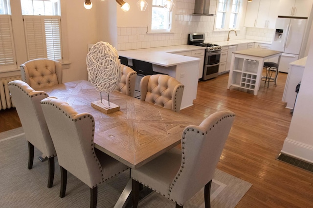 dining room with light hardwood / wood-style floors and sink