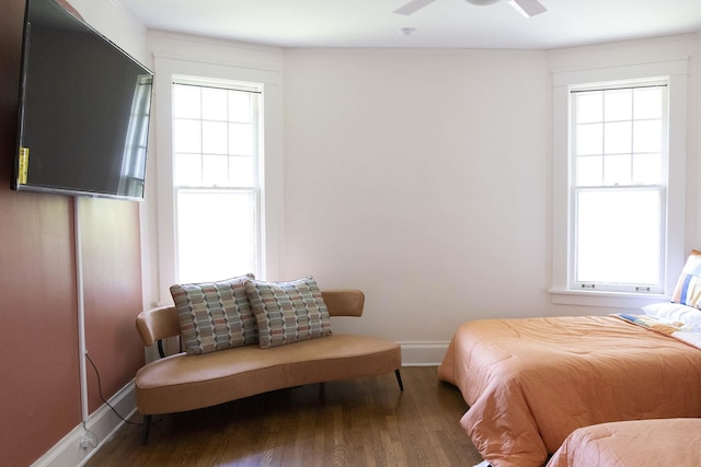 bedroom with ceiling fan, wood-type flooring, and multiple windows