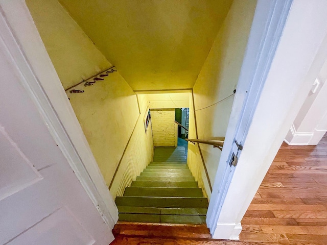 staircase with hardwood / wood-style flooring