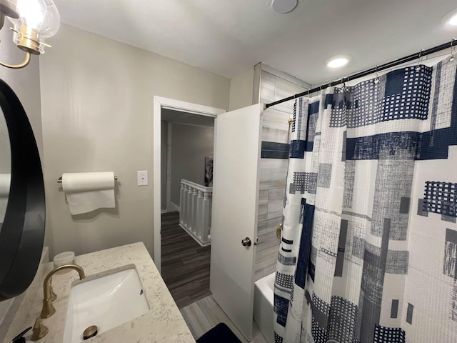 bathroom featuring vanity, wood-type flooring, and shower / bath combo with shower curtain