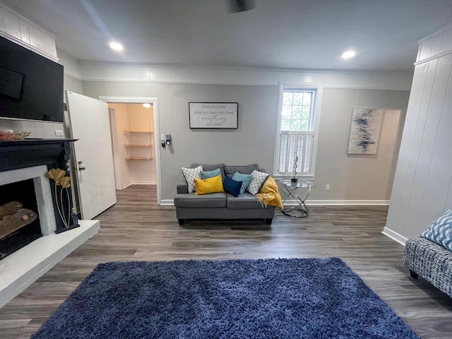 living room featuring dark hardwood / wood-style floors and ornamental molding