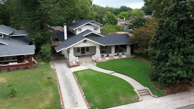 view of front of house with a porch and a front lawn