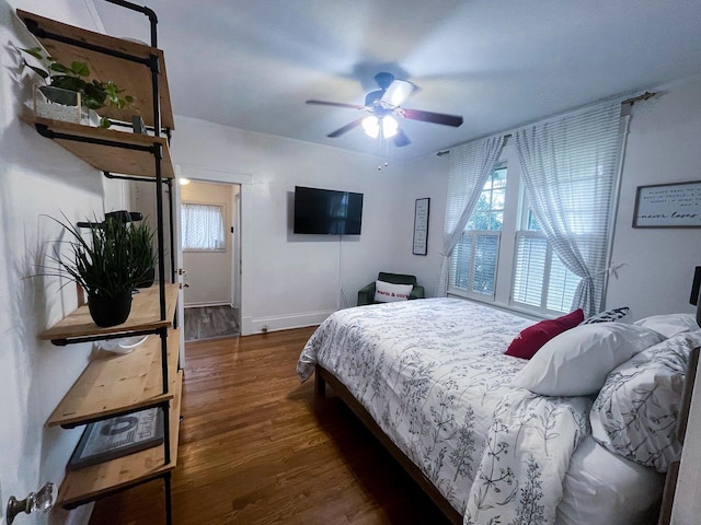 bedroom featuring ceiling fan and dark wood-type flooring