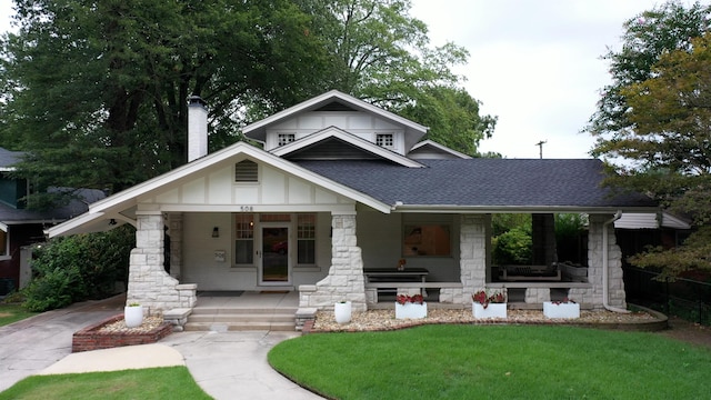 view of front of property with covered porch and a front yard