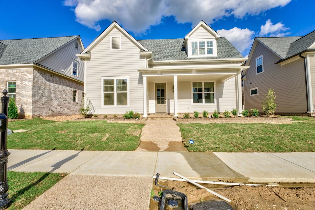 view of front of house featuring a front yard and covered porch