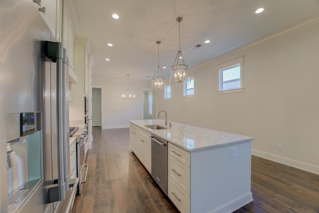 kitchen featuring stainless steel appliances, a center island with sink, white cabinetry, and hanging light fixtures