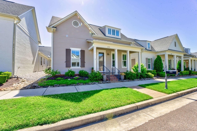 view of front of property with covered porch and a front lawn