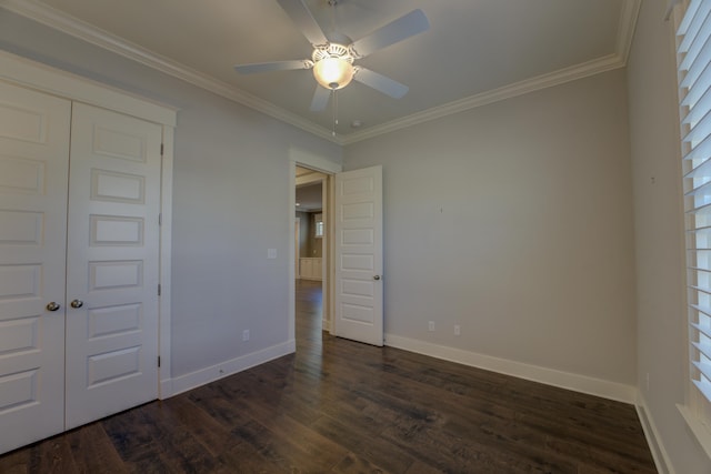 unfurnished bedroom featuring dark hardwood / wood-style flooring, a closet, ornamental molding, and ceiling fan