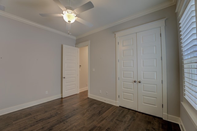 unfurnished bedroom featuring dark hardwood / wood-style flooring, a closet, ceiling fan, and ornamental molding