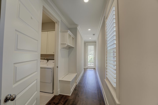 corridor with washing machine and clothes dryer, crown molding, and dark hardwood / wood-style flooring