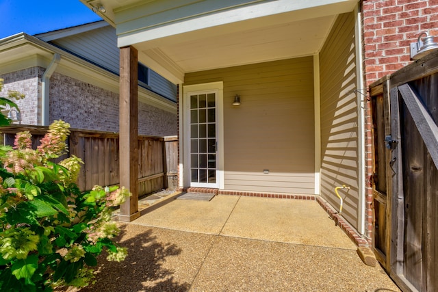 view of exterior entry featuring a patio area