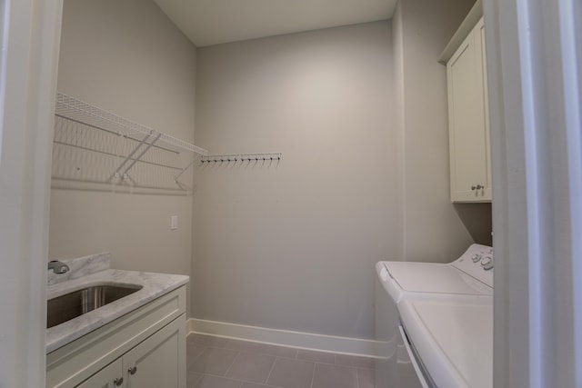 474 S Shea Rd, Collierville, TN 38017 - laundry room with cabinet space, washing machine and dryer, baseboards, and tile patterned floors