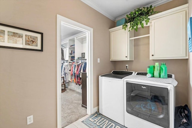 clothes washing area featuring cabinets, light colored carpet, crown molding, and washing machine and clothes dryer