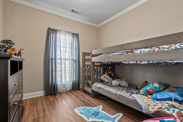 bedroom with wood-type flooring and ornamental molding