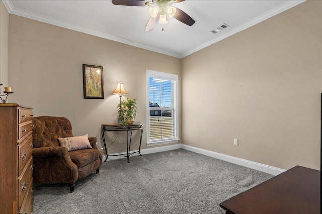 sitting room with carpet flooring, ceiling fan, and ornamental molding