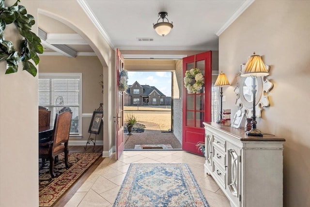 entrance foyer featuring beam ceiling, ornamental molding, light tile patterned floors, and coffered ceiling