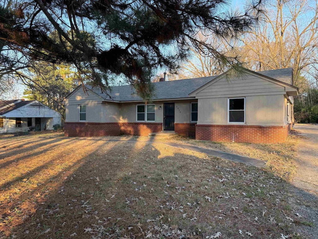 ranch-style home with a front lawn