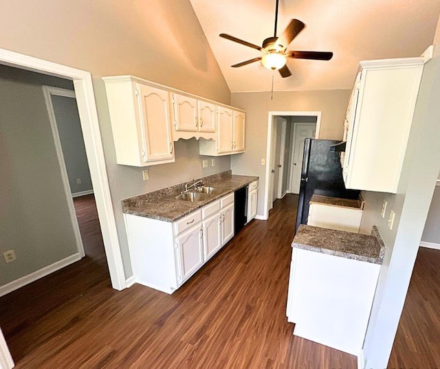 kitchen featuring white cabinets, dishwasher, lofted ceiling, and sink