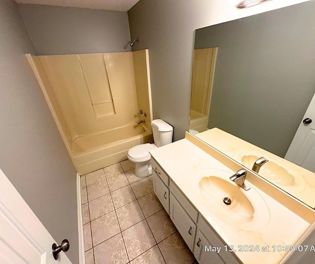 full bathroom featuring toilet, tile patterned floors, vanity, and bathing tub / shower combination