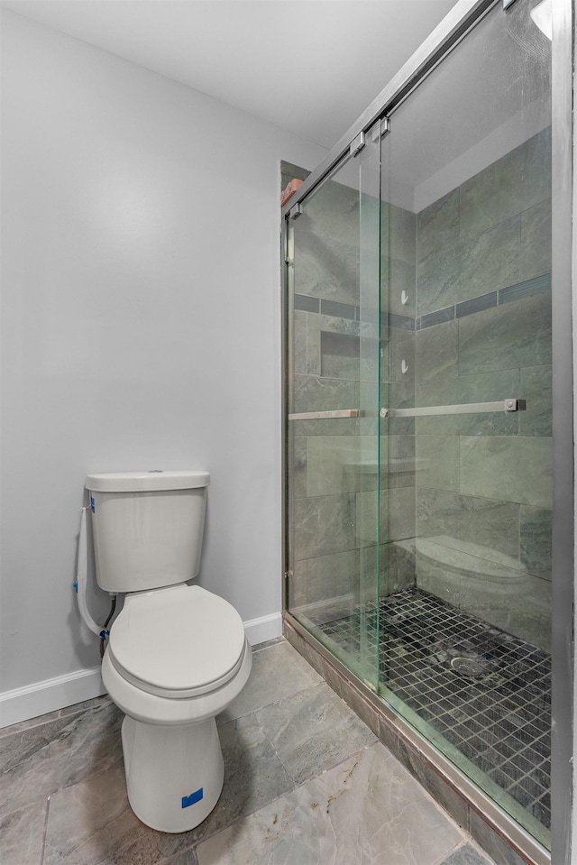 bathroom with toilet and walk in shower