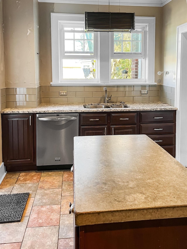 kitchen with dishwasher, backsplash, sink, ornamental molding, and dark brown cabinets