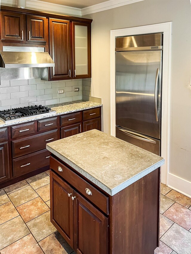 kitchen featuring decorative backsplash, ornamental molding, stainless steel appliances, light tile patterned floors, and range hood