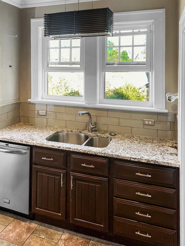 kitchen with dishwasher, decorative backsplash, dark brown cabinets, and sink