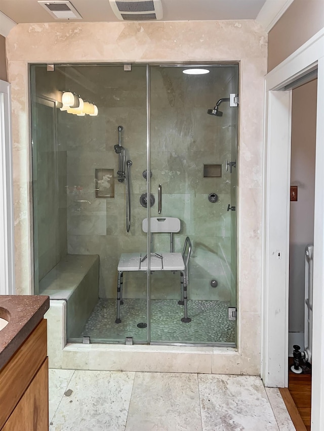 bathroom with tile patterned floors, vanity, and a shower with door